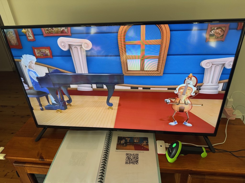 Image showing Pi Zero 2 and Netum QR scanner with the physical scanning booklet.
